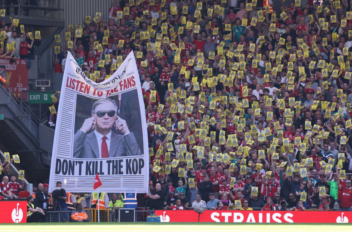 Fans of Liverpool protest rising ticket prices with posters that read 'Caution, Anfield's soul at risk'