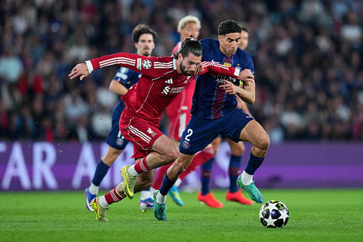 Dominik Szoboszlai of Liverpool battles for possession with Achraf Hakimi of Paris Saint-Germain during the UEFA Champions League 2025/26 Quarter-Final First Leg match between Paris Saint-Germain FC and Liverpool FC at Parc des Princes on April 08, 2026 in Paris, France.