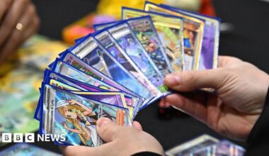 A competitor holds a deck showing a Determinazione Lylia card as they play the Pokémon Trading Card Game during the Pokemon Europe International Championships at ExCel London on February 13, 2026 in London, England.