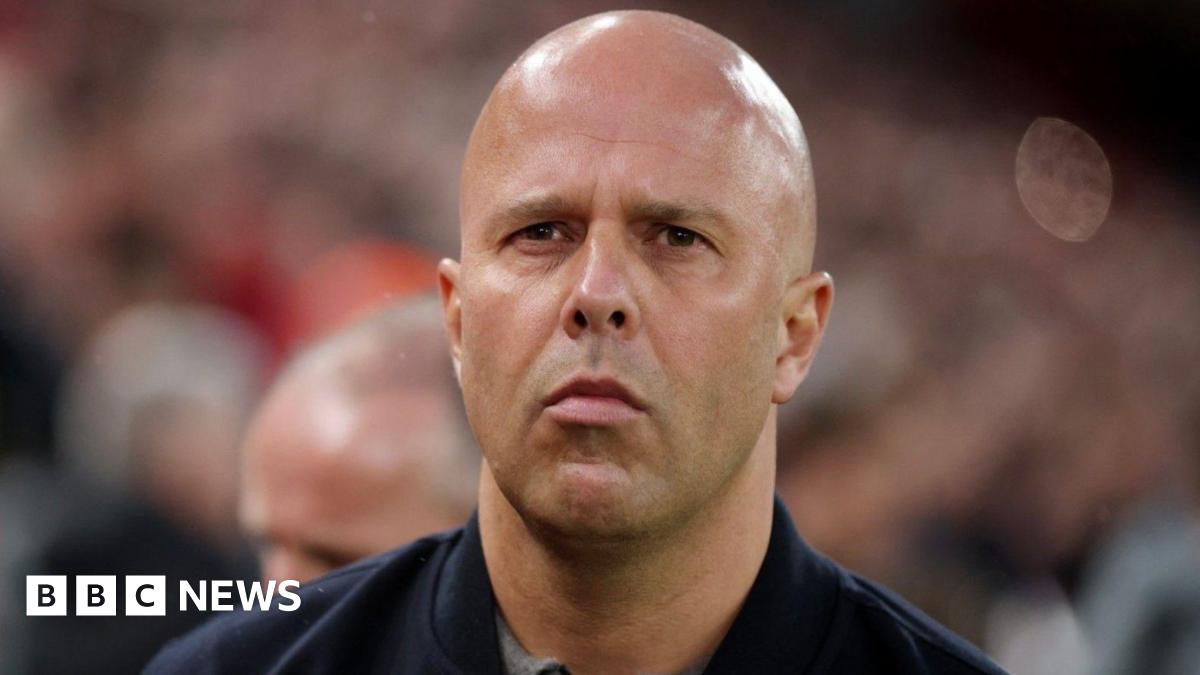 A close-up head shot of Arne Slot at Liverpool FC's Anfield stadium.
