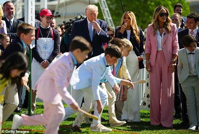 Children roll decorated, hard-boiled eggs are rolled across the White House lawn using spoons