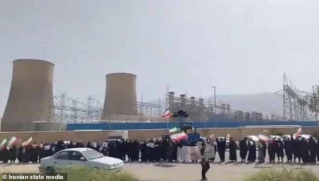 Video footage showed women and children waving flags as chanting blared on a loudspeaker at a power plant