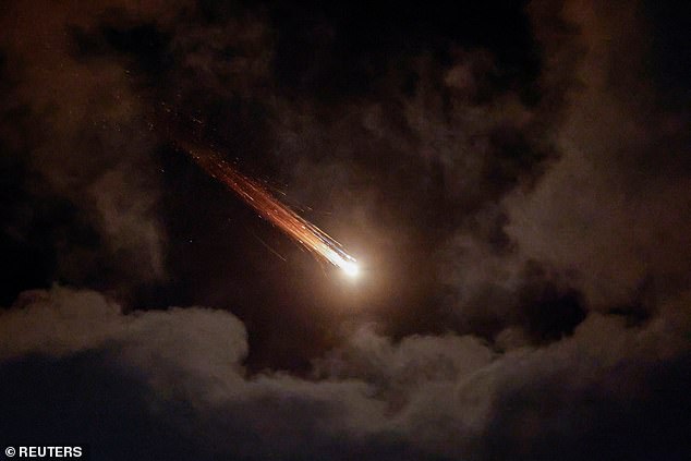 Streaks of light illuminate the sky during an interception attempt, amid the US-Israeli conflict with Iran, as seen from Ashkelon, Israel, April 7