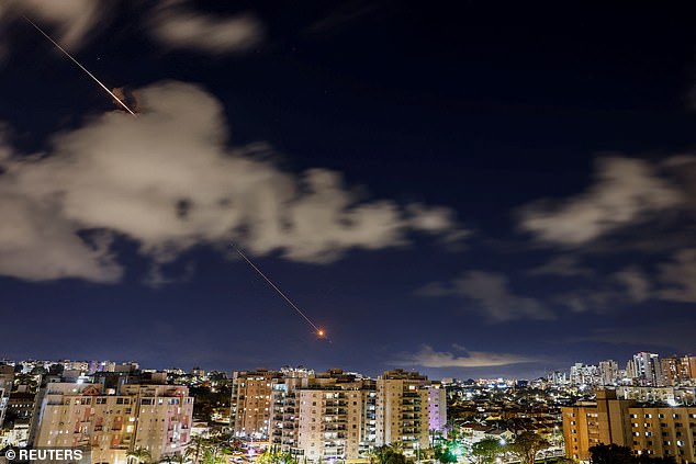 Streaks of light illuminate the sky during an interception attempt, amid the US-Israeli conflict with Iran, as seen from Ashkelon, Israel, April 7