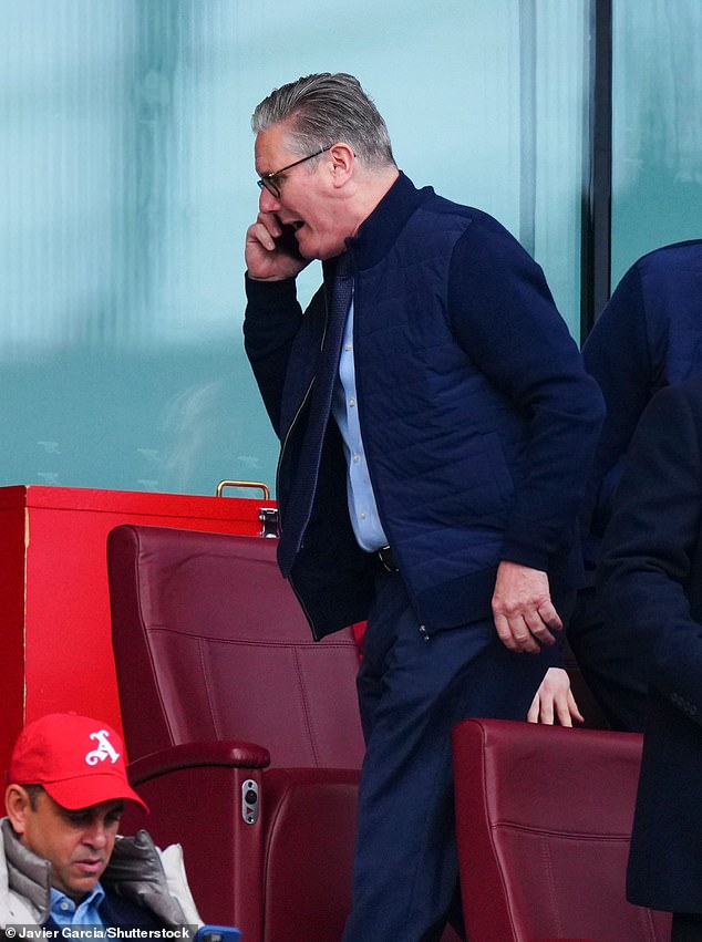 Russia has thumbed its nose at Sir Keir Starmer's threats to seize its sanctioned vessels by giving them naval escorts. Pictured: The PM takes a call during the Arsenal match on Saturday