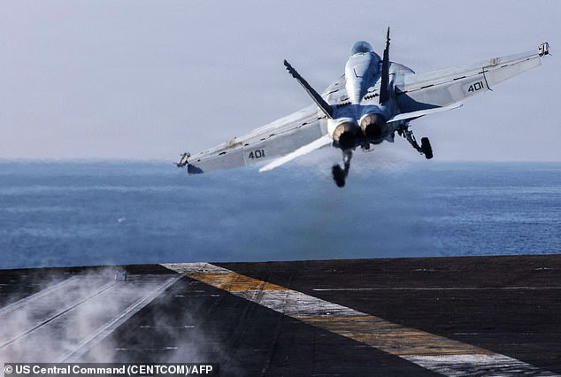 Some 6,000 troops aboard several warships are expected to arrive near the end of the month. Above, an F/A-18E Super Hornet launching from USS Abraham Lincoln