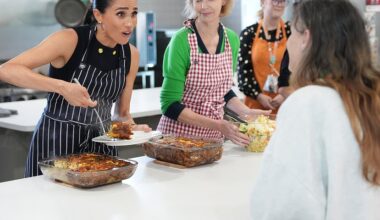 Theory emerges about the REAL reason Meghan was so dressed up during homeless shelter trip - as Harry visits war memorial