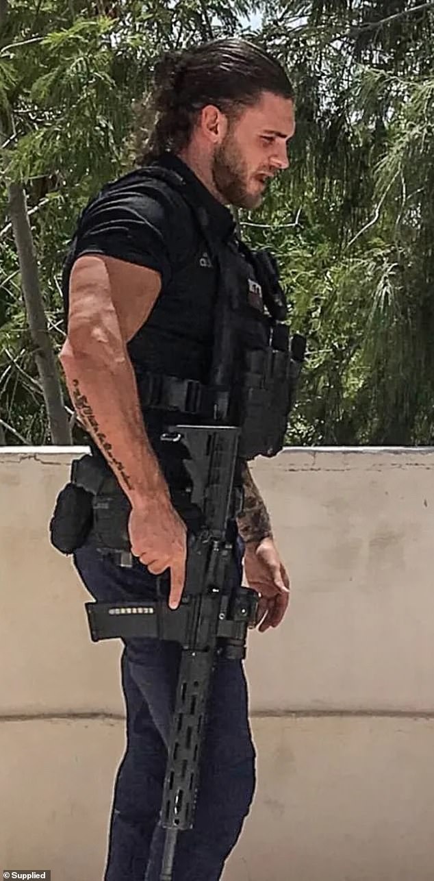 Pictured: Ex-soldier Grant Gale, 34, sporting a bulletproof vest and wielding a firearm
