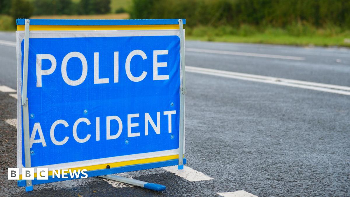 Blue police accident sign with white writing on the side of a road