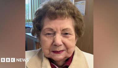 Shirley Billam smiling at the camera. She has short hair and is wearing a white jacket.
