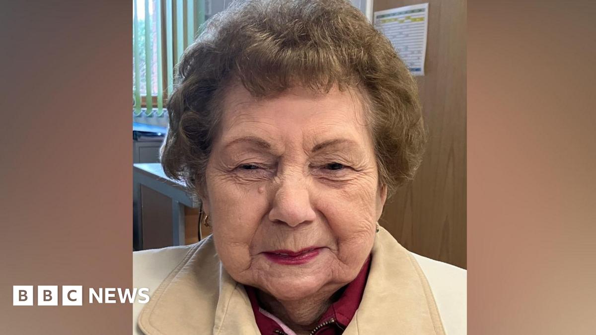Shirley Billam smiling at the camera. She has short hair and is wearing a white jacket.