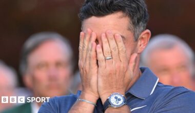 Rory McIlroy covers his face with his hands