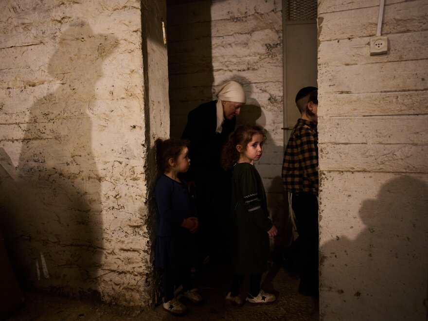 People take cover in a bomb shelter as air raid sirens warn of incoming Iranian missile strikes in Bnei Brak, Israel, Wednesday.