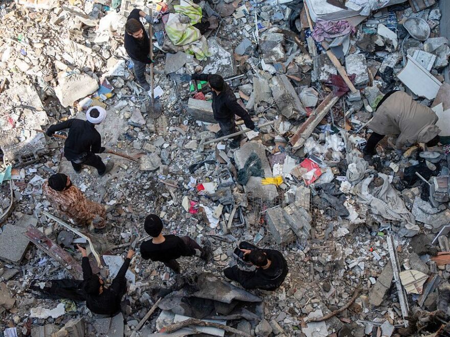 People sift through rubble in the aftermath of a drone attack on a residential building in which one civilian was killed on March 31, 2026 in eastern Tehran, Iran.