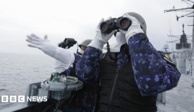 Two Romanian navy officers from the Romanian Navy frigate 'King Ferdinand' monitor the target for a canon live fire shooting during the NATO naval drill 'Sea Shield 26' in the Black Sea