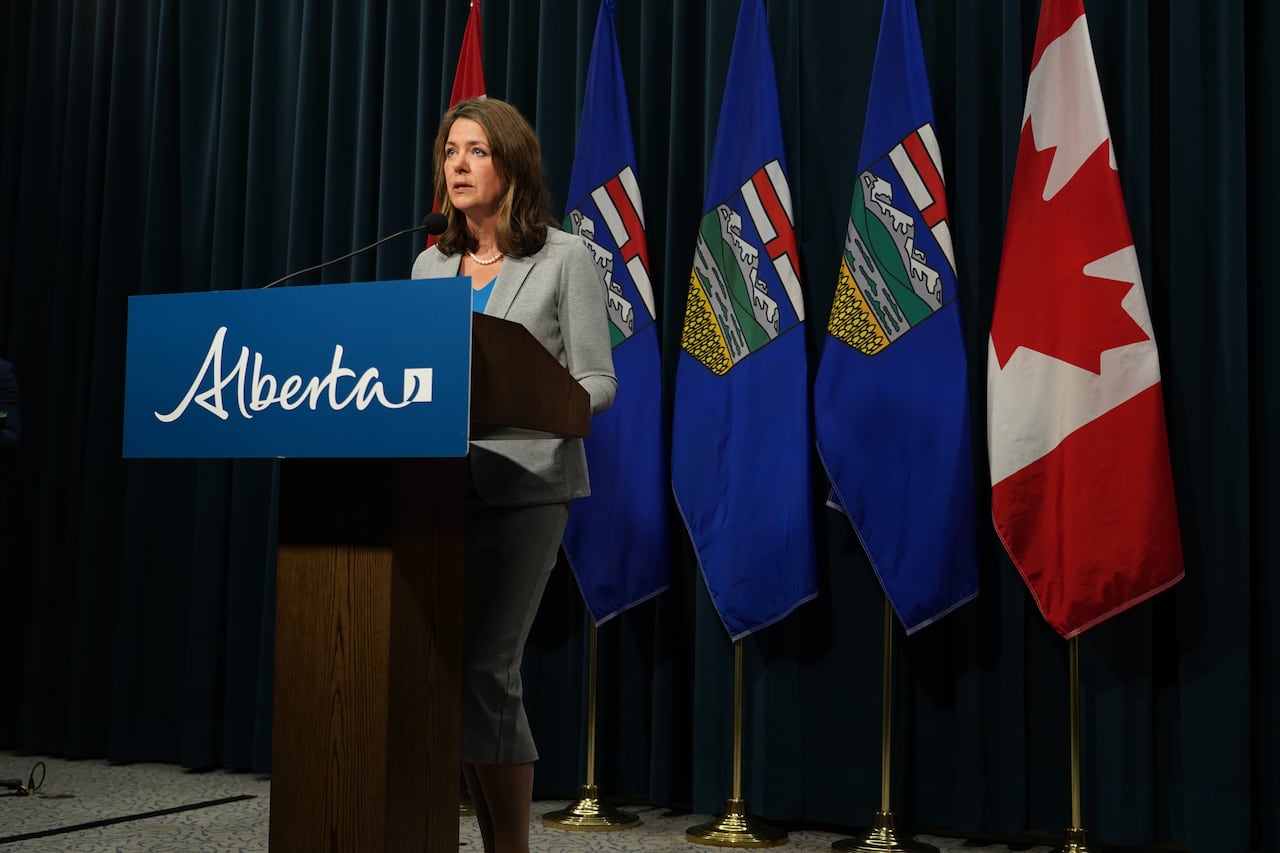 A woman stands behind a podium.