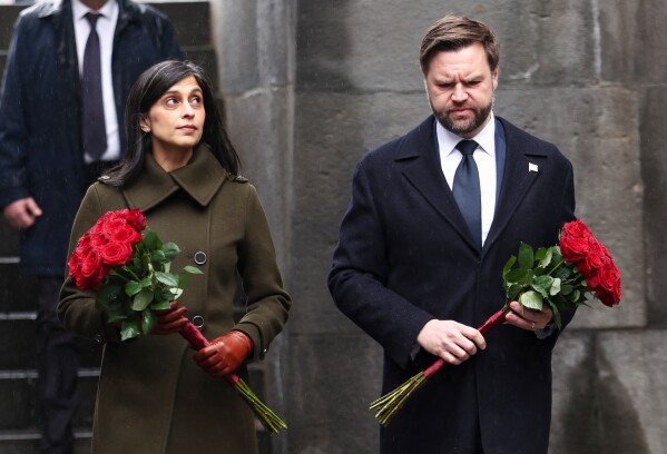 U.S. Vice President JD Vance and second lady Usha Vance hold flowers as they walk towards the eternal flame at the Tsitsernakaberd Armenian Genocide Memorial in Yerevan, Armenia Tuesday, Feb. 10, 2026. (Kevin Lamarque/Pool Photo via AP)