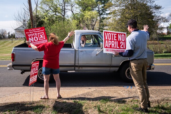 A truck driver stops to wave at members of the Madison County Republican Committee as they hold signs opposing the Virginia redistricting referendum, during the early voting period, Friday, April 3, 2026, in Madison, Va. (AP Photo/Julia Demaree Nikhinson)