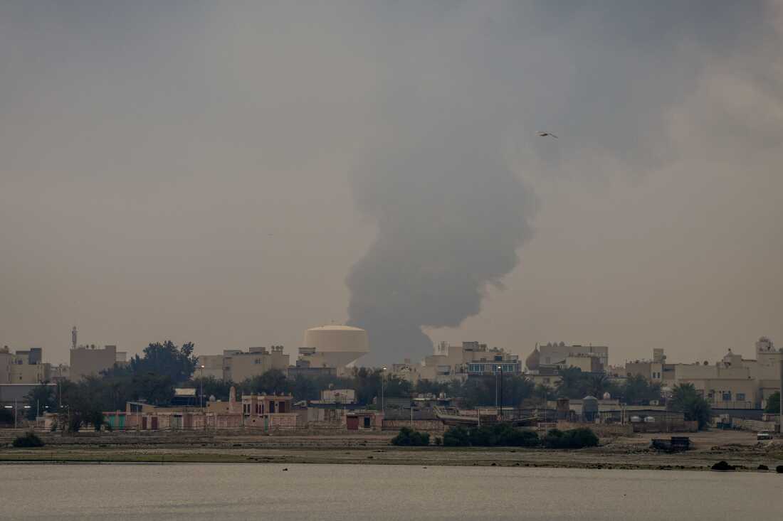 A plume of smoke rises after a reported Iranian strike on fuel tanks in Muharraq, Bahrain, on March 12.