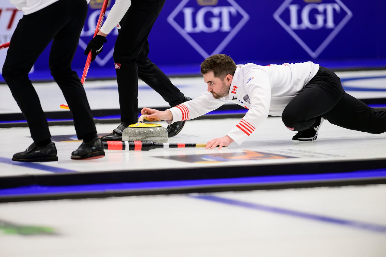 A Canadian curler delivers the rock.