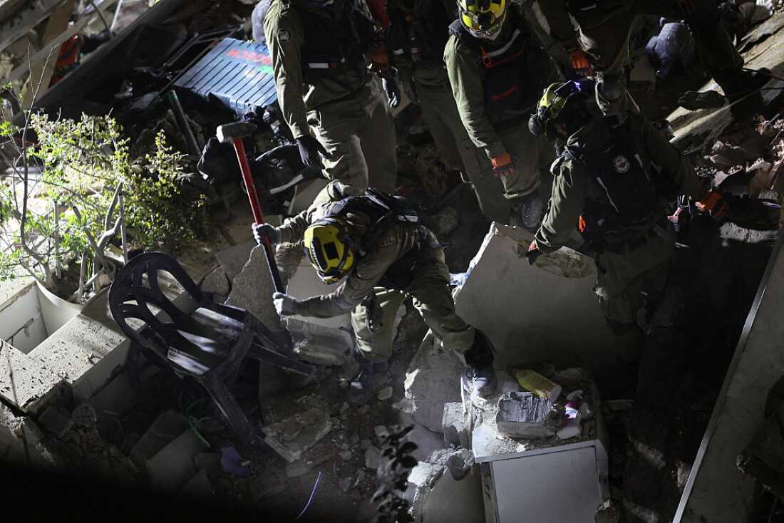 Israeli search and rescue personnel work at the site of a residential building destroyed in an Iranian strike in the northern city of Haifa on April 5, 2026.