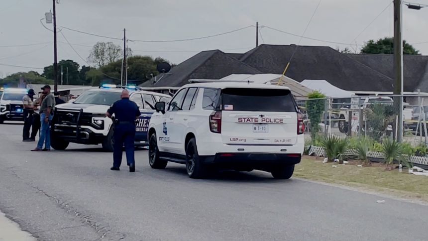 Louisiana state police officers arrive on the scene, after a car crashed into a crowd at the Louisiana Lao New Year Festival.