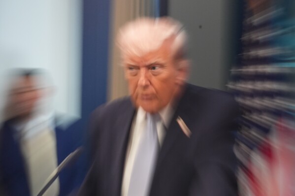 A zoom lens and slow shutter speed technique shows President Donald Trump speaking with reporters in the James Brady Press Briefing Room at the White House, Monday, April 6, 2026, in Washington.(AP Photo/Alex Brandon)