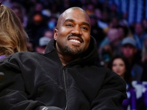 Kanye West, known as Ye, watches the first half of an NBA basketball game between the Washington Wizards and the Los Angeles Lakers, on March 11, 2022, in Los Angeles. (AP Photo/Ashley Landis, File)
