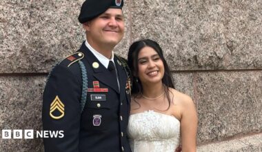 US Army Staff Sgt Matthew Blank wears his army uniform as he hugs his wife Annie Ramos in her white strapless wedding gown.