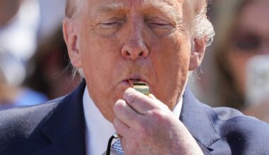 General news article image depicting a current event, featuring people in a business setting discussing a topic.