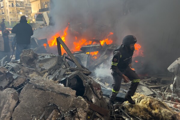 Rescuers gather at the site of an Israeli airstrike in central Beirut, Lebanon, Wednesday, April 8, 2026. (AP Photo/Hussein Malla)