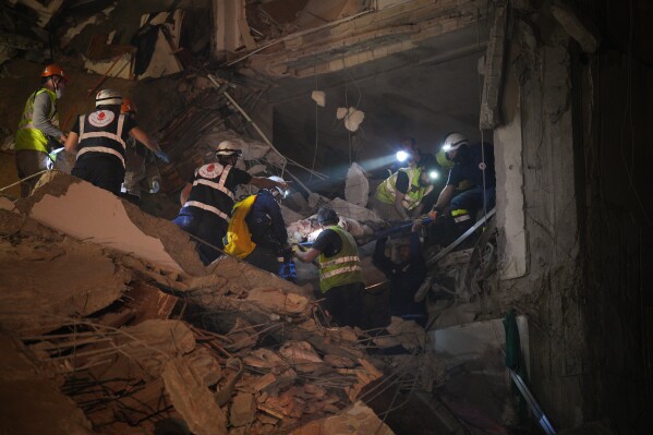 Rescuers rescue an injured man from a destroyed building that was hit in an Israeli airstrike in central Beirut, Lebanon, Wednesday, April 8, 2026. (AP Photo/Emilio Morenatti)