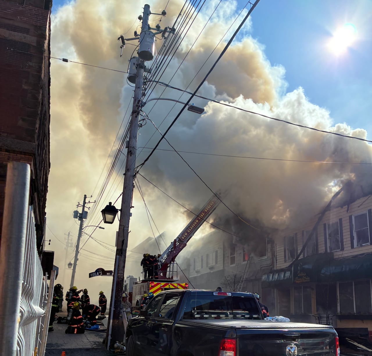 fire truck parked in front of a burning building