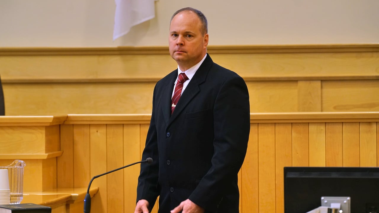 A man in a black suit.