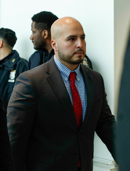 New York police officer Erik Duran who is charged with hurling a plastic cooler at a man fleeing officers on a motorized scooter, causing a crash that killed the driver, arrives to his manslaughter trial at the Bronx Criminal Court in New York, Friday, Feb. 6, 2026. (AP Photo/Kena Betancur)