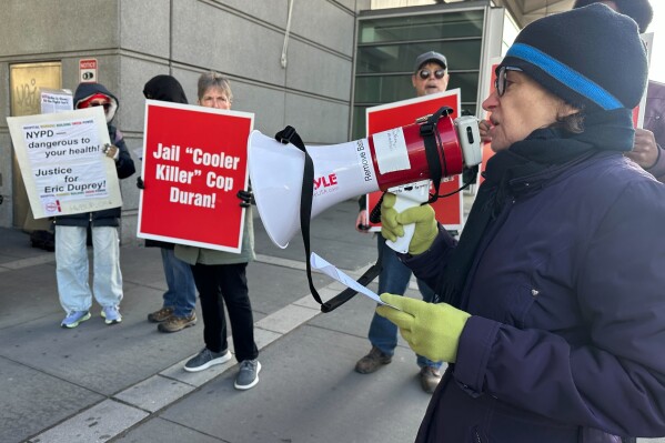 Demonstrators stand outside the Bronx County Hall of Justice in New York, Thursday, April 9, 2026, where former New York City police sergeant Erik Duran is set to be sentenced for tossing a picnic cooler full of drinks at a fleeing suspect, Eric Duprey, who then crashed his motorized scooter and died. (AP Photo/David Martin)