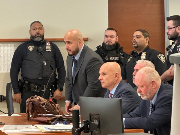 Former New York City police sergeant Erik Duran stands during his sentencing hearing at the Bronx County Hall of Justice Thursday, April 9, 2026, New York, for tossing a picnic cooler full of drinks at a fleeing suspect, Eric Duprey, who then crashed his motorized scooter and died. (AP Photo/Michael R. Sisak)