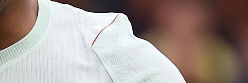 An extreme closeup of a green fabric tenting on someone's shoulder.