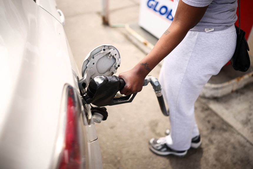 A woman fills up her vehicle's tank at a gas station in the Hamilton Heights neighborhood in the Manhattan borough of New York on March 31, 2026.