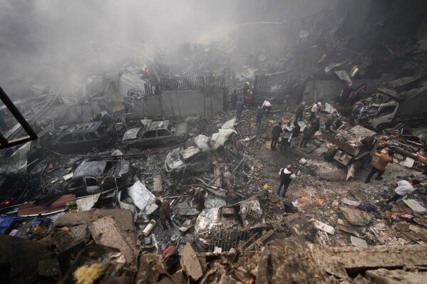 Residents gather at the site of an Israeli airstrike in Beirut, Lebanon, Wednesday, April 8, 2026. (AP Photo/Hussein Malla)
