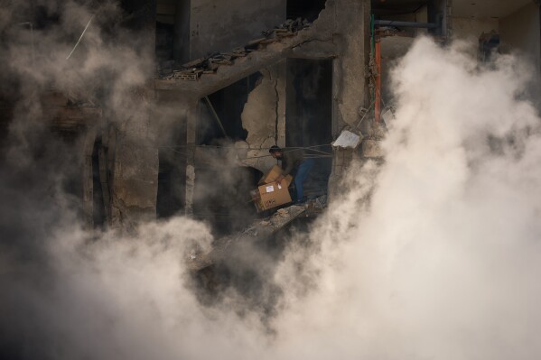 A man gathers his belongings from his home, which has been destroyed in an Israeli airstrike a day earlier in Beirut, Lebanon, Thursday, April 9, 2026. (AP Photo/Emilio Morenatti)