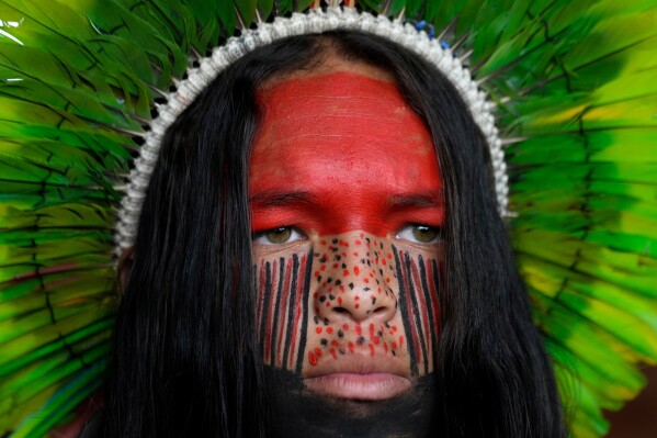 A Pataxo man looks on before a march at the Acampamento Terra Livre 2026, an Indigenous mobilization focused on land rights and environmental protection, in Brasilia, Brazil, Thursday, April 9, 2026. (AP Photo/Eraldo Peres)