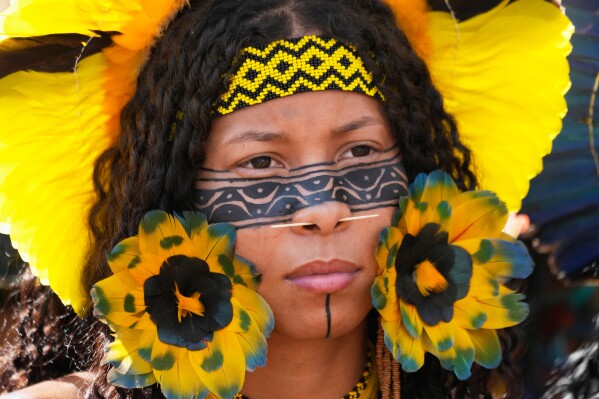 A Xakriaba Indigenous woman attends a march during the annual "Acampamento Terra Livre," or Free Land Encampment, Brazil's largest annual Indigenous mobilization that focuses on land rights and environmental protection, in Brasilia, Brazil, Tuesday, April 7, 2026. (AP Photo/Eraldo Peres)