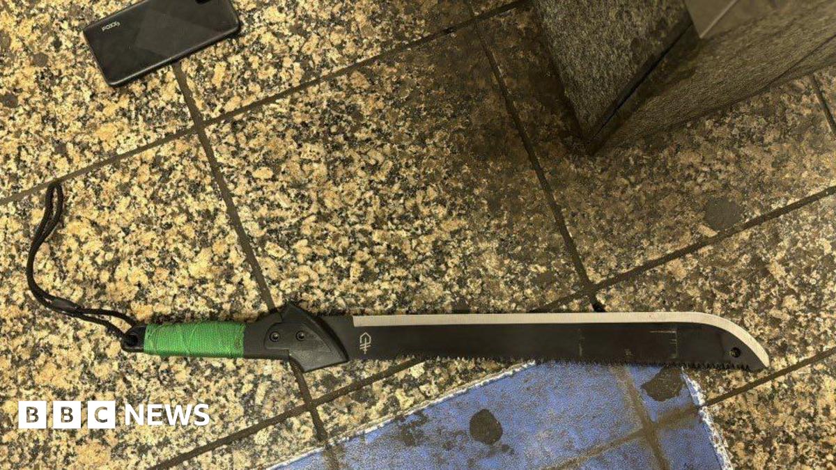 A black machete lies on the train platform.