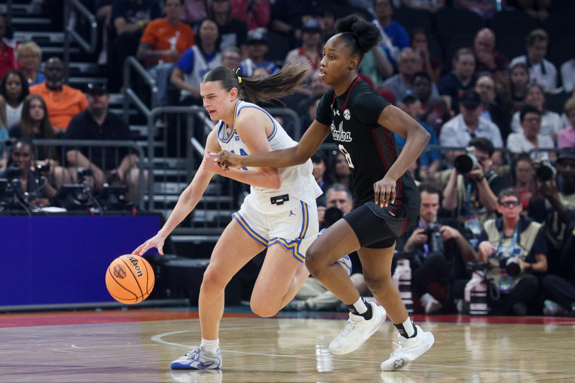 UCLA forward Gabriela Jaquez dribble past Carolina Gamecocks forward Joyce Edwards during the NCAA women's championship.