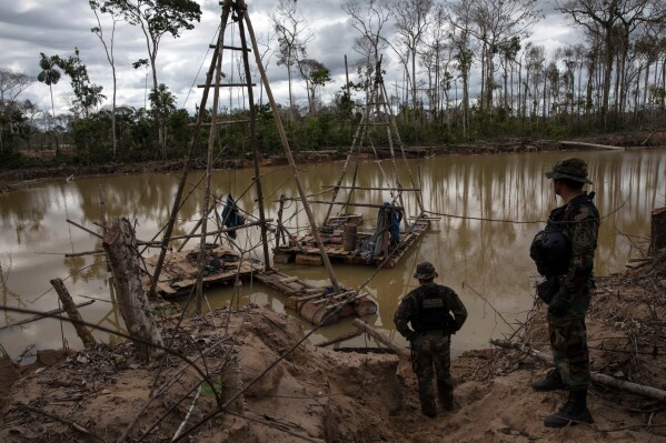 Police special forces stand next to illegal mining machinery in Peru's Tambopata province on April 1, 2019. (AP Photo/Rodrigo Abd, File)