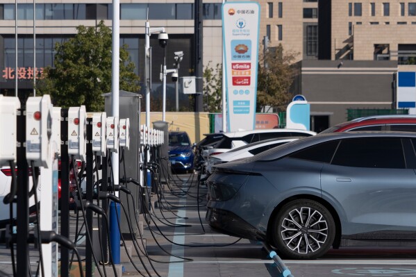 Electric vehicle charging stations are seen in Beijing, on Oct. 11, 2024. (AP Photo/Caroline, File)
