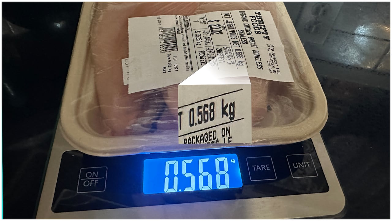 Organic chicken being weighed with a scale. The scale weight and the net weight on the package both show the same amount: .568 kilograms. 