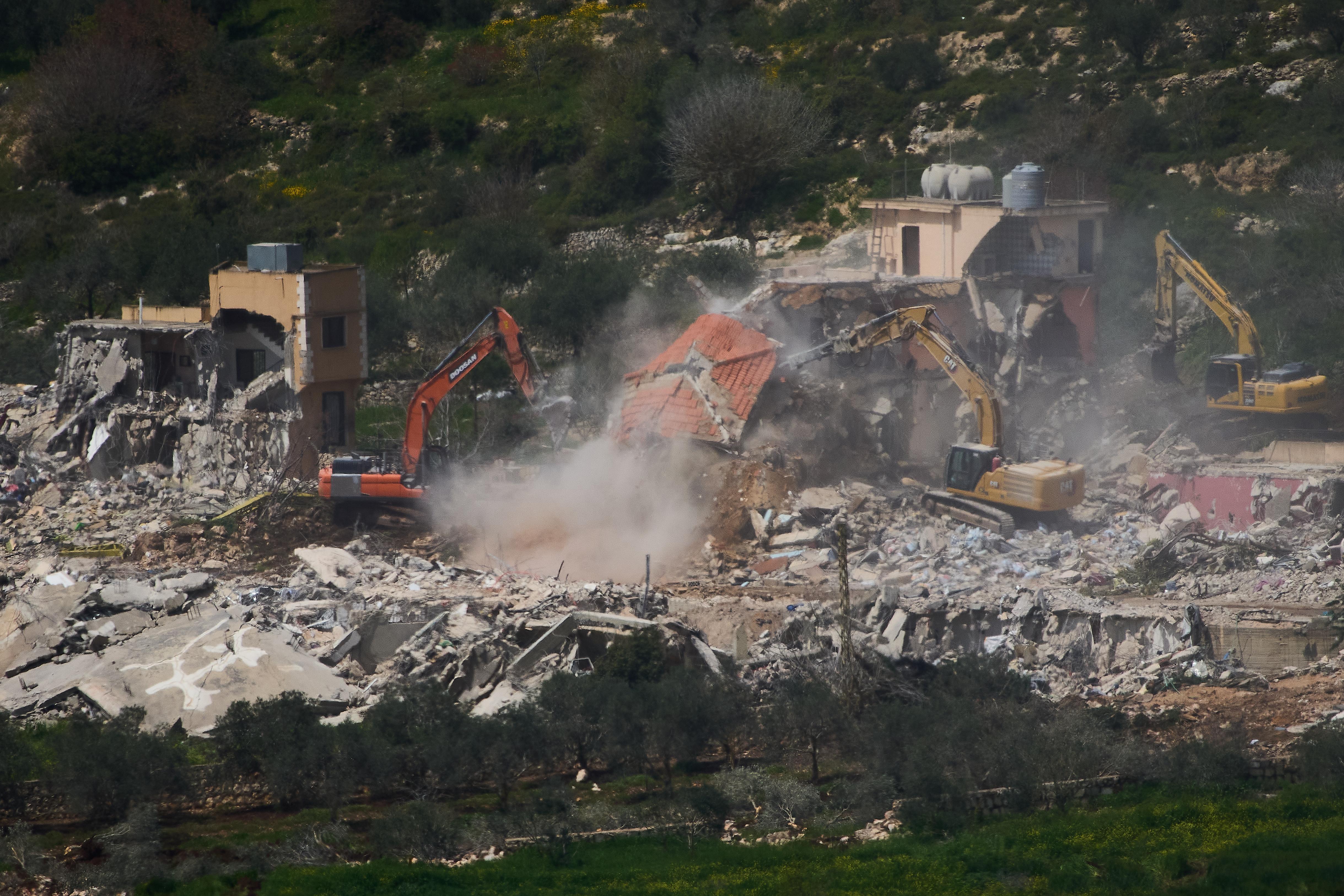 Israeli bulldozers demolish homes in southern Lebanon.