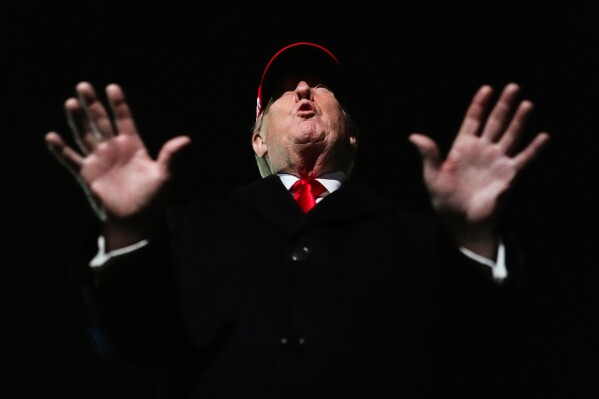 President Donald Trump speaks with reporters after disembarking Air Force One, Sunday, April 12, 2026, at Joint Base Andrews, Md. (AP Photo/Julia Demaree Nikhinson)